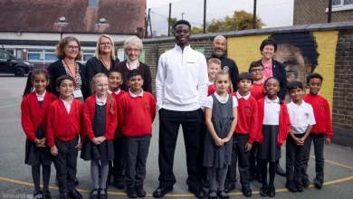 Football star Saka surprises school pupils