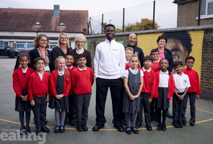 Football star Saka surprises school pupils