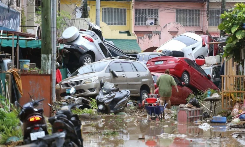 Typhoon leaves at least 2 dead, traps people on roofs and submerges cars in central Philippines