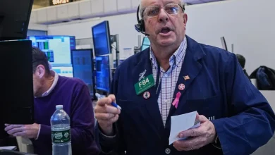 A fragile US stock market flips between gains and losses following its wildest day since April