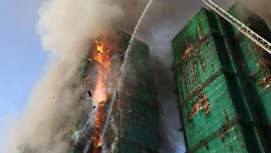 At least 13 people dead and more trapped after fire engulfs Hong Kong high-rises