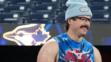 Blue Jays' Davis Schneider goes barefoot in the park before Game 6