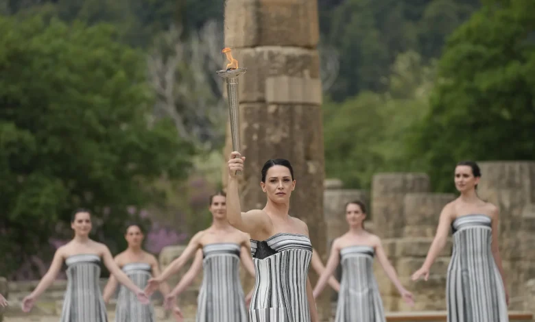 Cross-country skiing legend Stefania Belmondo presents, Greek alpine skier AJ Ginnis first torchbearer: the first secrets of the Milan/Cortina 2026 Olympic flame lighting ceremony revealed