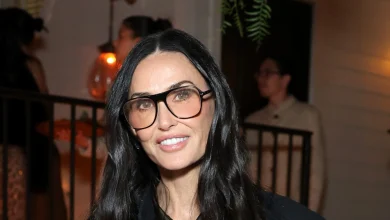 Demi Moore embraces the heritage trend in a cosy argyle jumper, tartan pleated skirt and knee-high boots