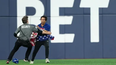 Fan with American flag runs onto field in Toronto during Game 6 of World Series