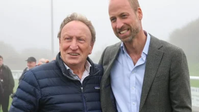 Football legend Neil Warnock poses for a photo with 'fan' Prince William after royal helped stranded local football club
