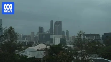 Heavy rain forecast for parts of Queensland after two rescued from floodwaters