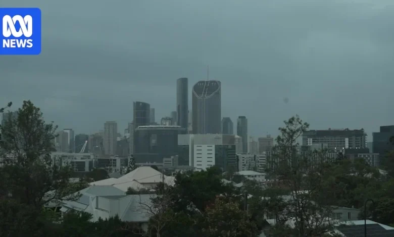 Heavy rain forecast for parts of Queensland after two rescued from floodwaters