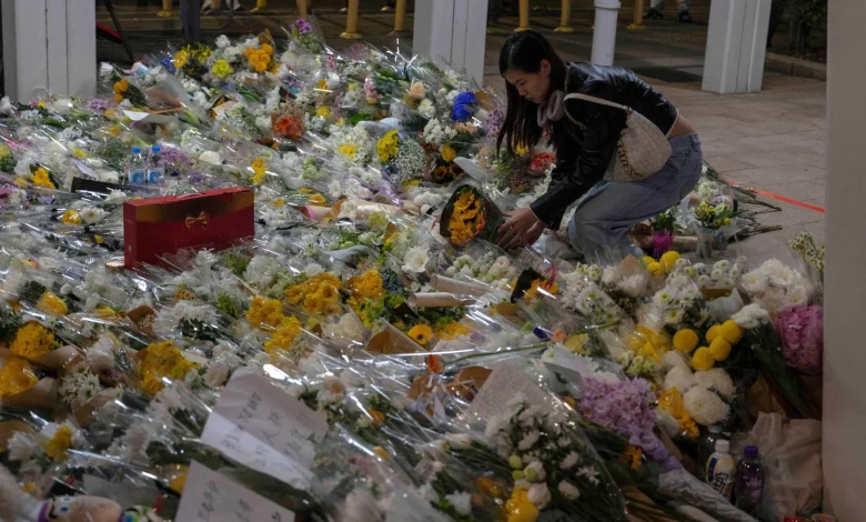 Hong Kong mourns those lost to fire as investigators search for remains