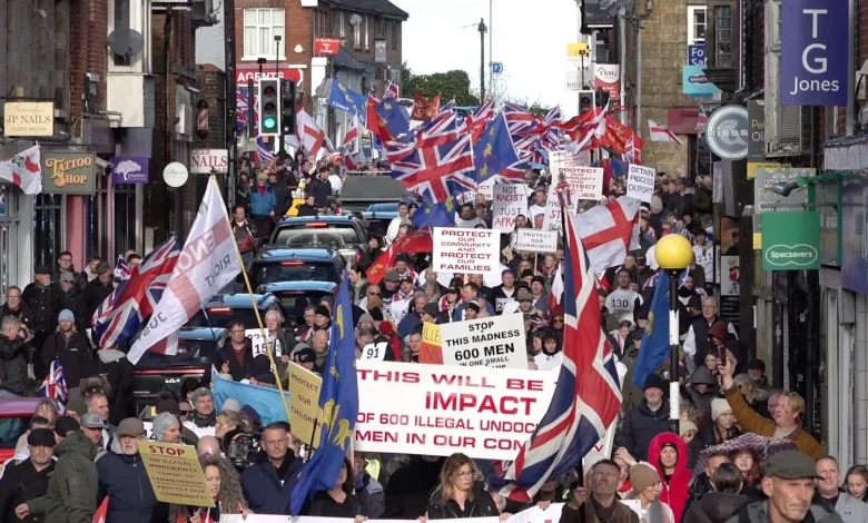 Hundreds march through Sussex town over asylum camp plans | ITV News