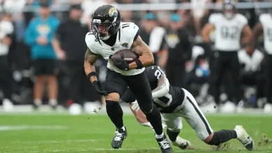 Jaguars' Parker Washington is helped off the field with hip injury