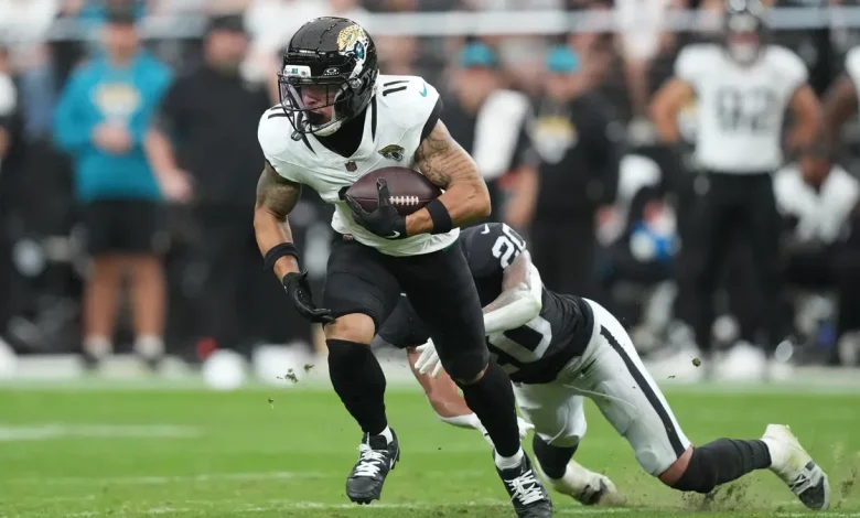 Jaguars' Parker Washington is helped off the field with hip injury