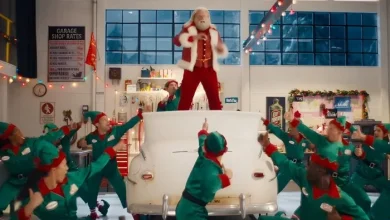 John Travolta’s Santa channels Danny Zuko for Capital One