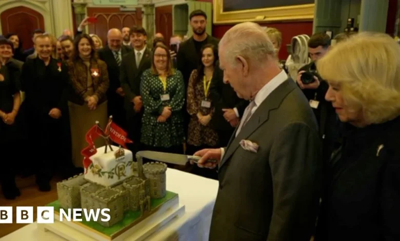 King Charles cuts his birthday cake during Wales visit