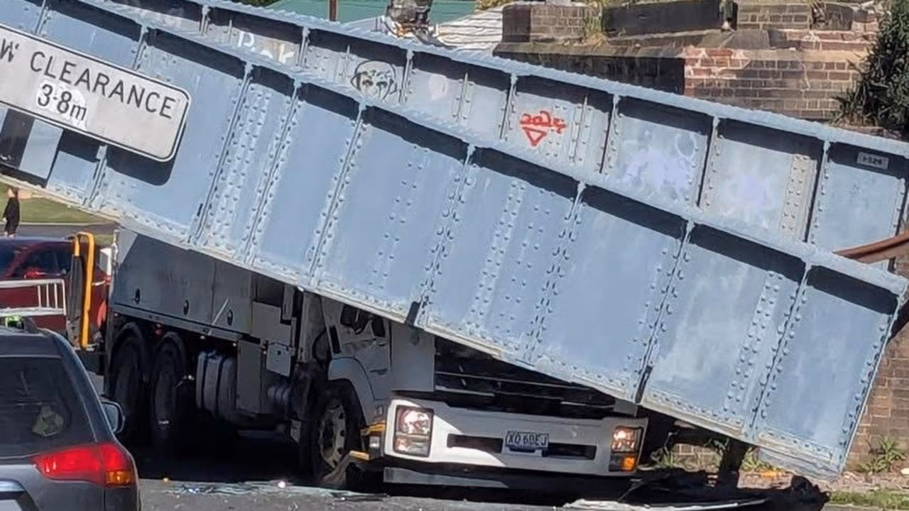 Man trapped after truck slams into bridge
