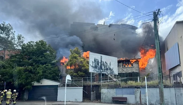 Multiple crews fighting house fire next to Brisbane cinema