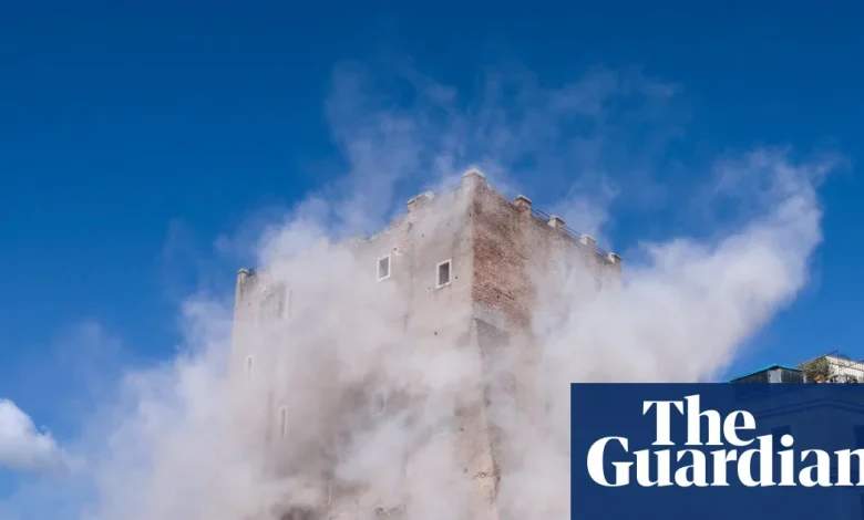 Rescuers try to free man trapped in partly collapsed medieval tower in Rome
