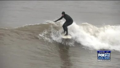 Surfers spend the snow day catching some waves