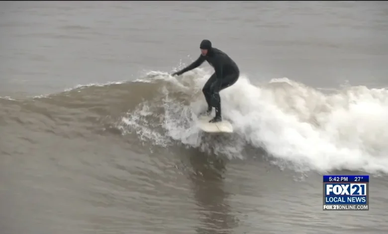 Surfers spend the snow day catching some waves