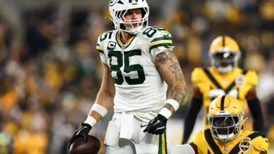 Tucker Kraft carted to locker room with knee injury