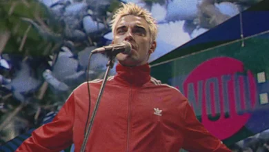 Watch Robbie Williams travel back in time to perform on 'The Word' for new 'Pretty Face' video