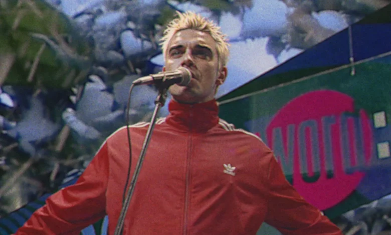 Watch Robbie Williams travel back in time to perform on 'The Word' for new 'Pretty Face' video