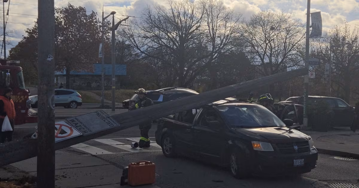 Woman injured after hydro pole falls on vehicle in Toronto’s west end