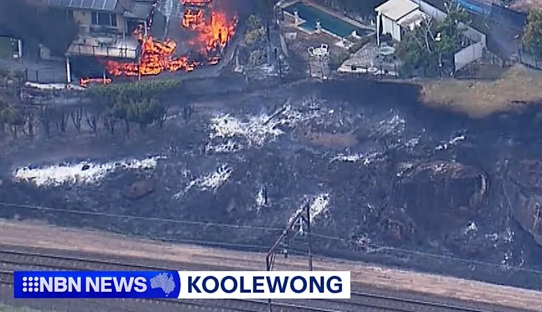 Bushfires engulf homes near Sydney as city swelters through 40-degree scorcher