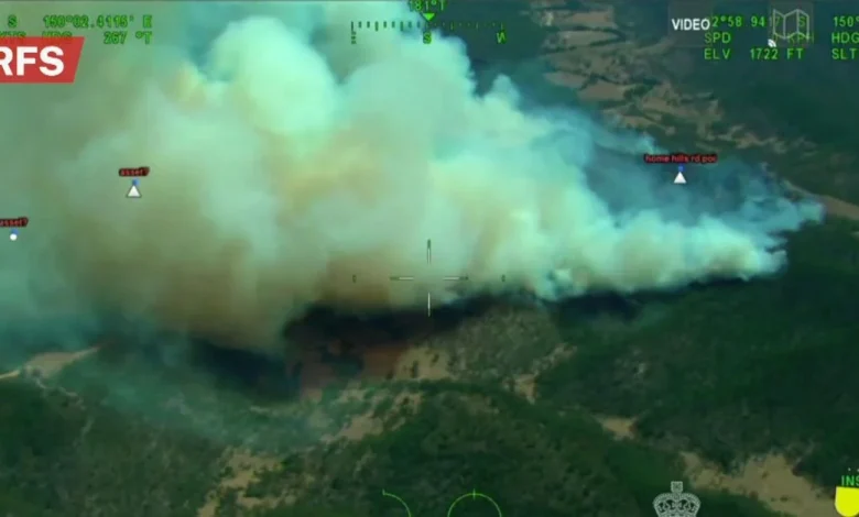 Firefighters issue emergency warning as NSW blaze threatens homes