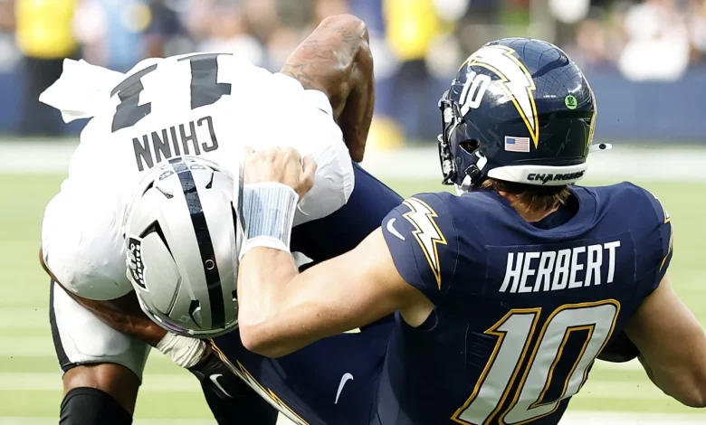 Justin Herbert returns with a protective glove on his left hand