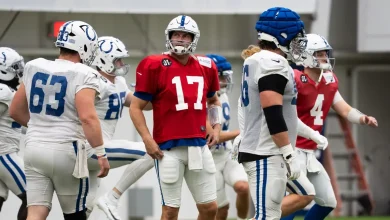 Philip Rivers pulls cleats from a trophy case to use with the Indianapolis Colts