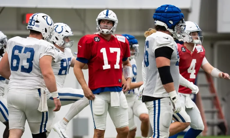 Philip Rivers pulls cleats from a trophy case to use with the Indianapolis Colts