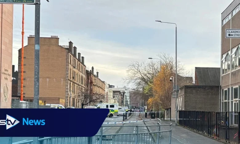Police cordon off city street as forensic tent erected at scene