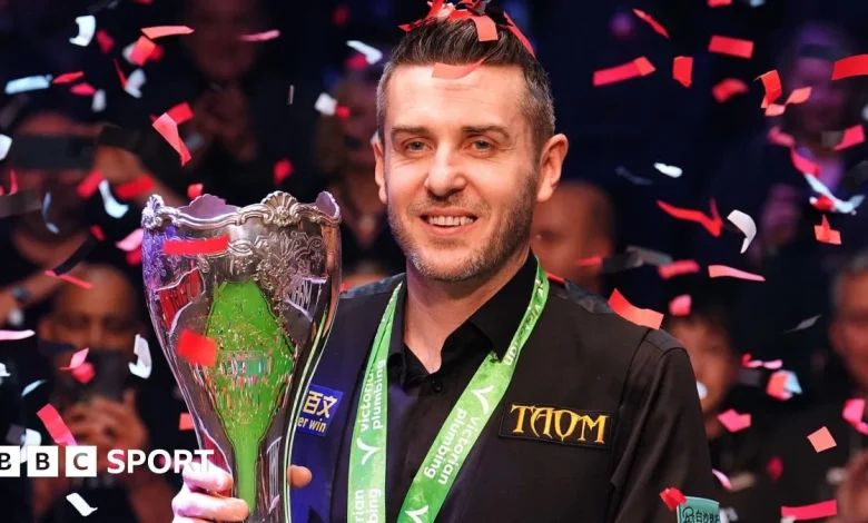 Selby holds off spirited Trump to win third UK title