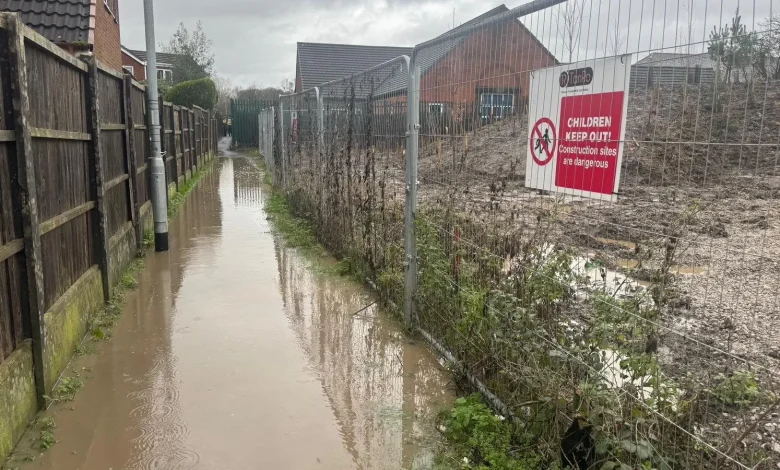 We have to piggyback our kids to school due to 60ft warehouse flooding our homes